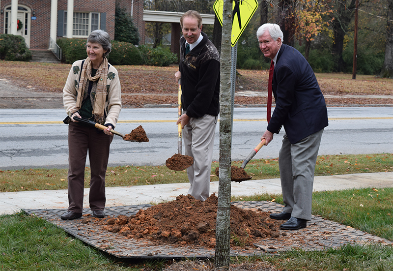 Susan Galloway; Dr. Michael Rischbieter, professor of biology; and Bob Staton, president plant the first of 11 new willow oak trees at Presbyterian College.