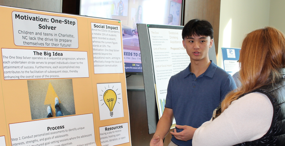 Xupheng Ly explains his project during Service Entrepreneurship poster session.