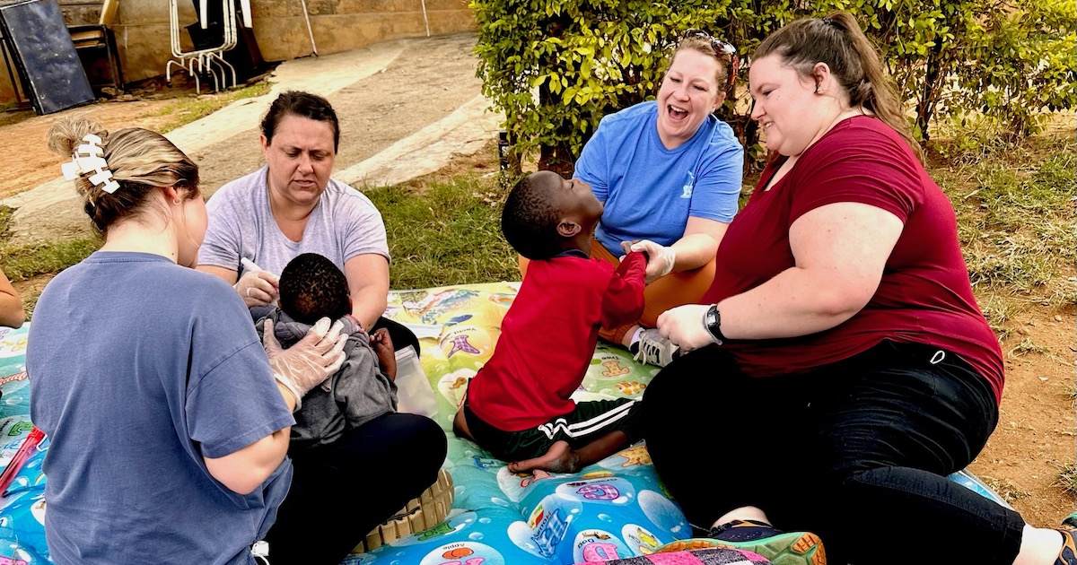 PC occupational therapy students work with Kenyan children during trip abroad.