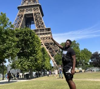 Jalen Banks in front of the Eifel Tower in Paris