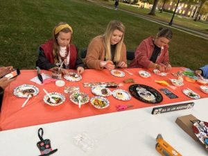 Group of students decorating cookies at the fall festival