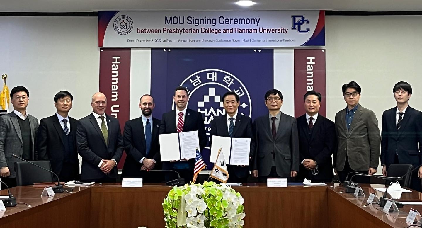 Presbyterian College and Hannam University representatives holding the signed agreement