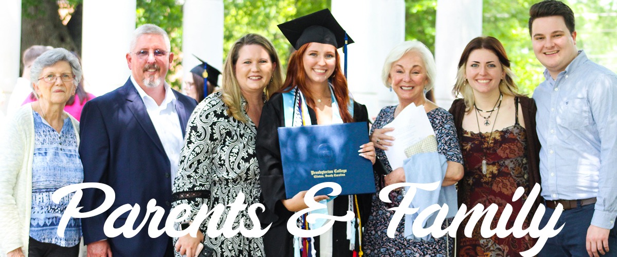 Parents and Family Header, PC Grad in the center with her family around her at graduation