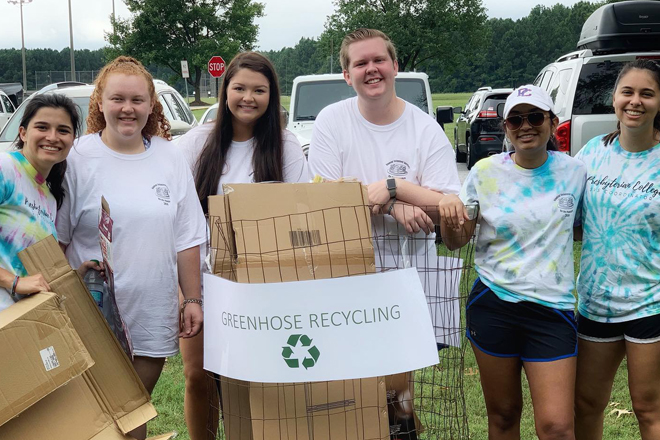 Group of students holding a litter bin for recycling paper