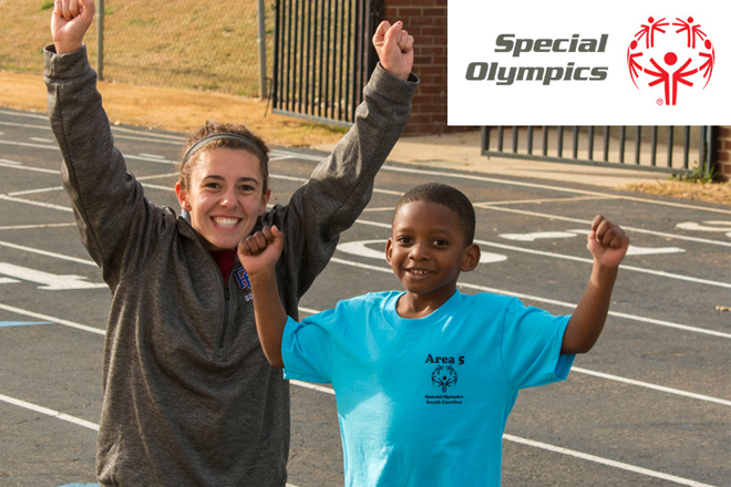 Student volunteer with a young sportsman in the Special Olympics