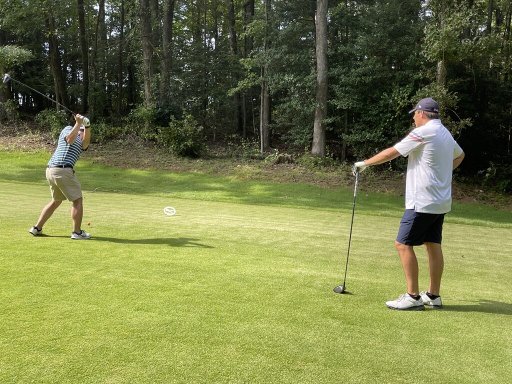 Two men playing golf at the tournament