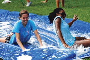 New students having fun on the slip and slide