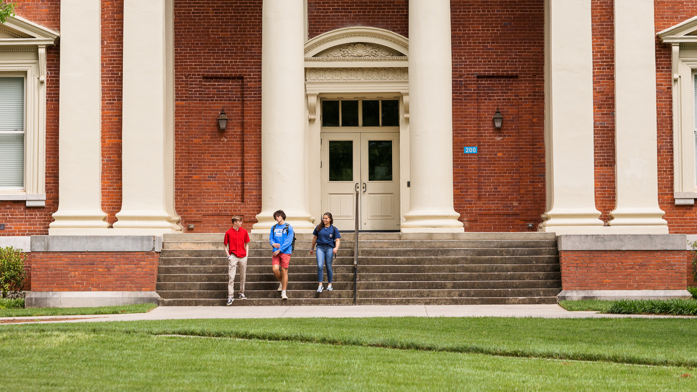 Presbyterian College students walking in front of Neville Hall.