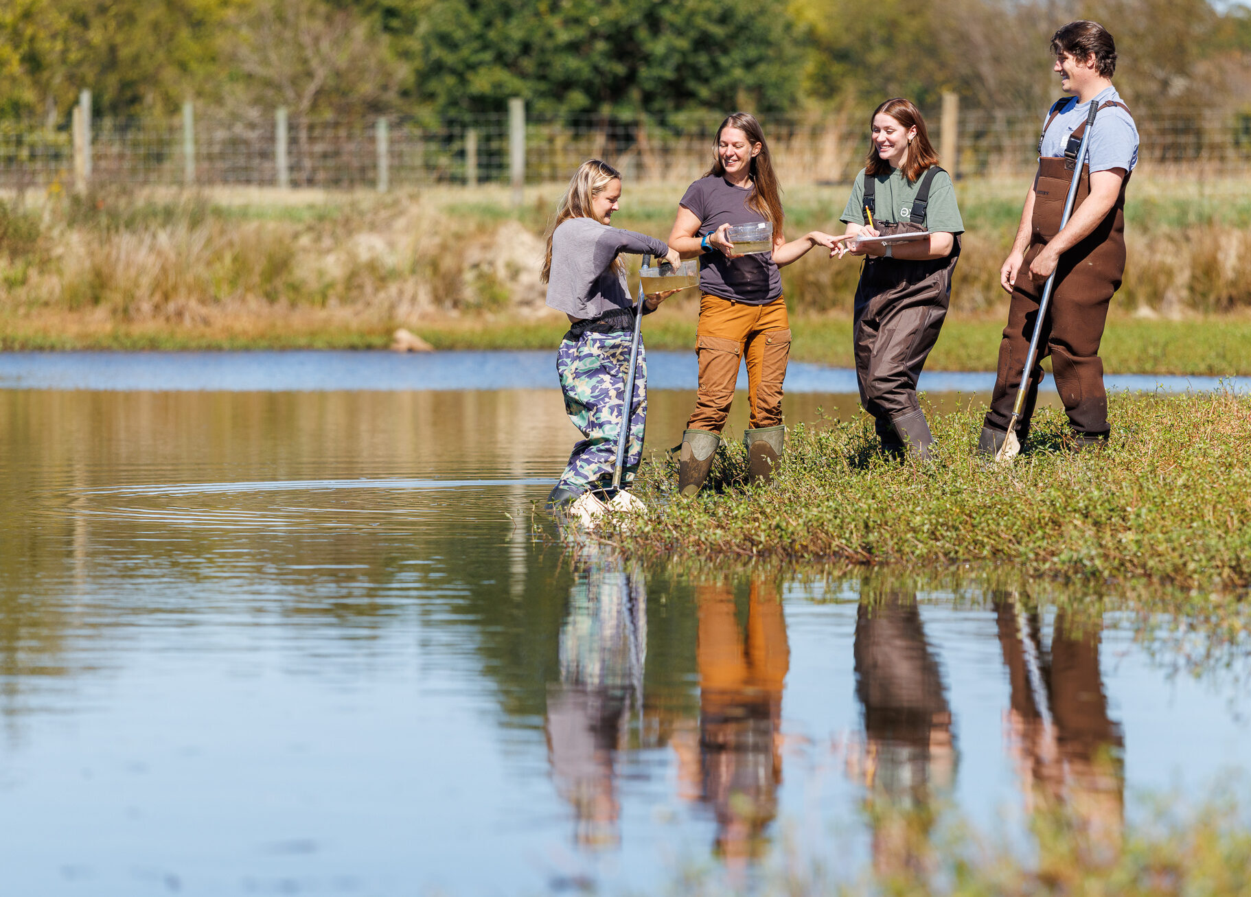 Presbyterian College Biology students and professor having class outside.