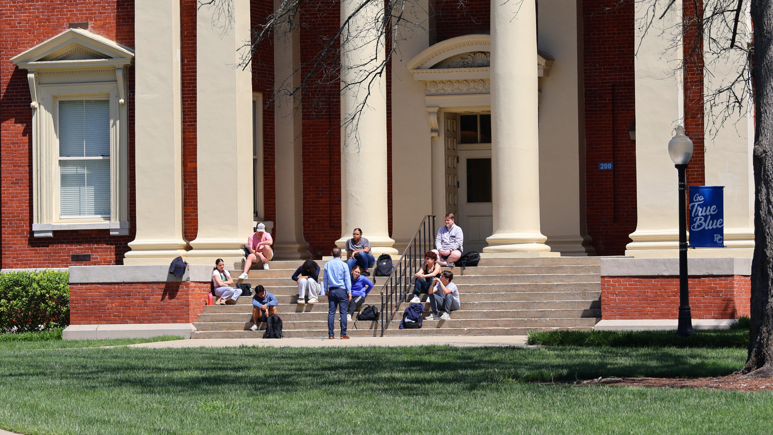 Presbyterian College students having class on the front steps of Neville Hall.