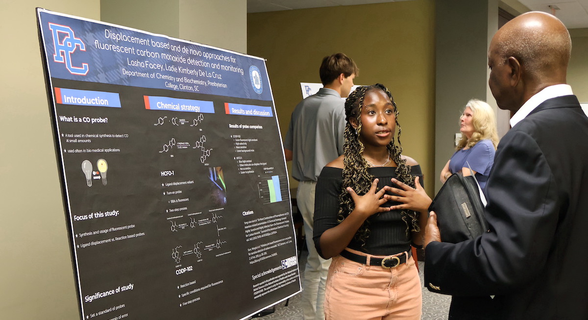 Presbyterian College student Lasha Facey presents her findings during a poster session at the annual Summer Research Symposium.