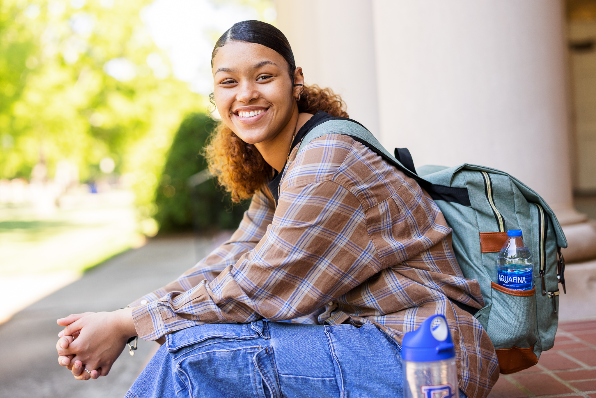 Presbyterian College student sitting on the Belk Auditorium steps.
