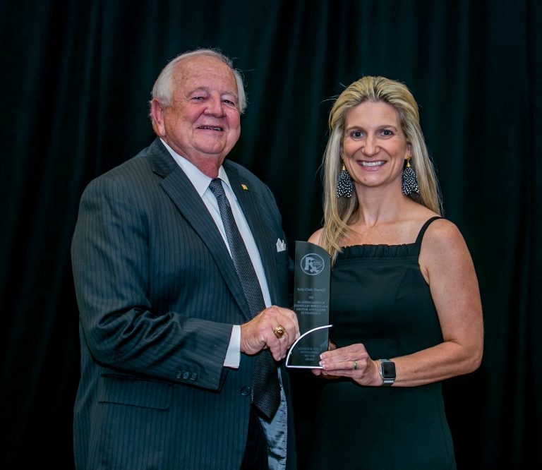 Dr. Kelly Clark with the award||