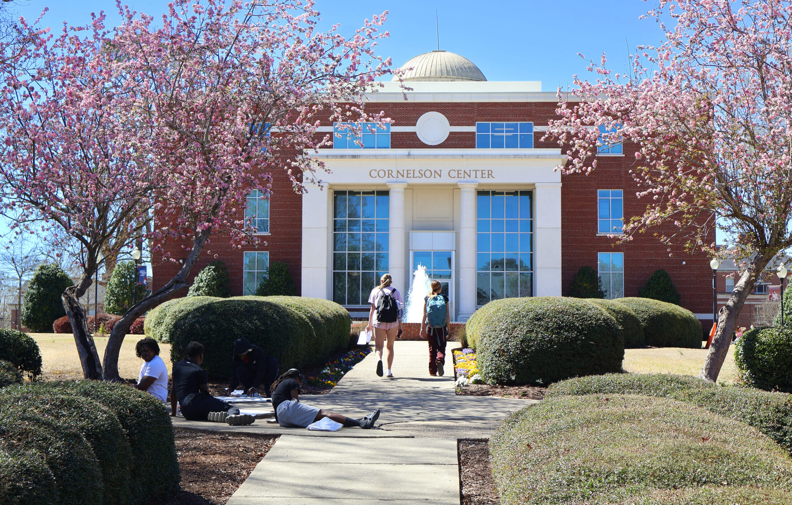 Presbyterian College students walking by the fountain near the Cornelson Lobby.