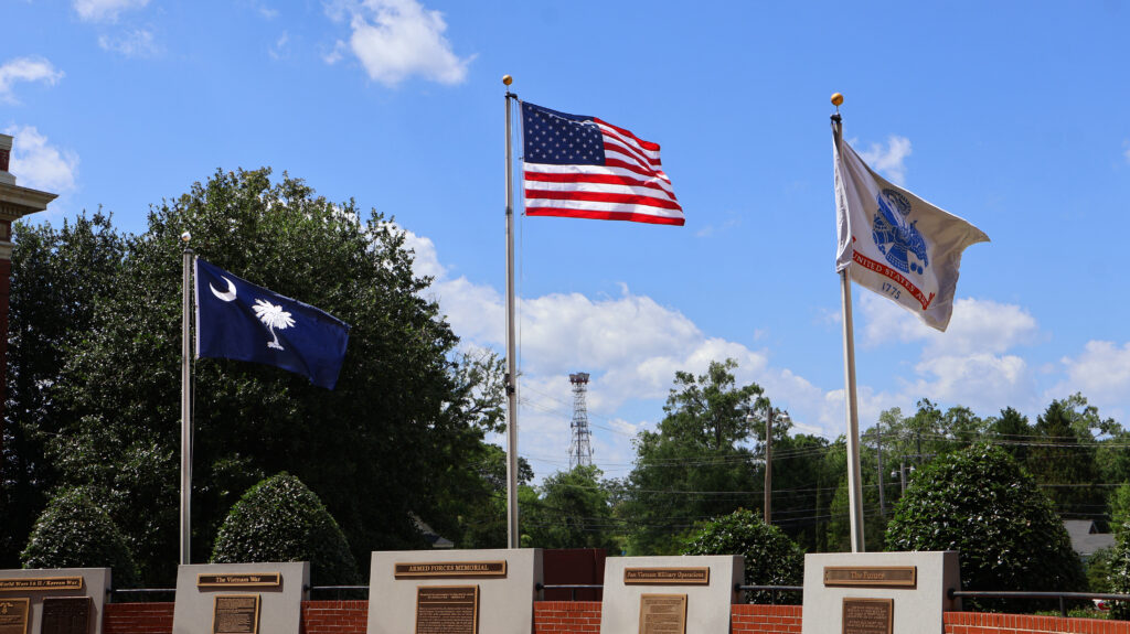 Picture of the United States flag, the South Caroline State flag, and the United States Army flag.