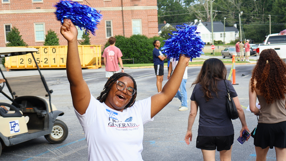 Presby First+ student cheering with pom poms at Presbyterian College's New Student Orientation