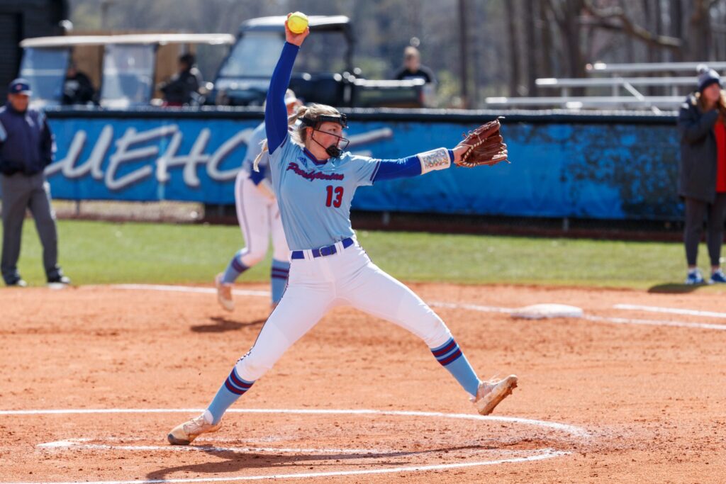 Softball player throwing a pitch. 