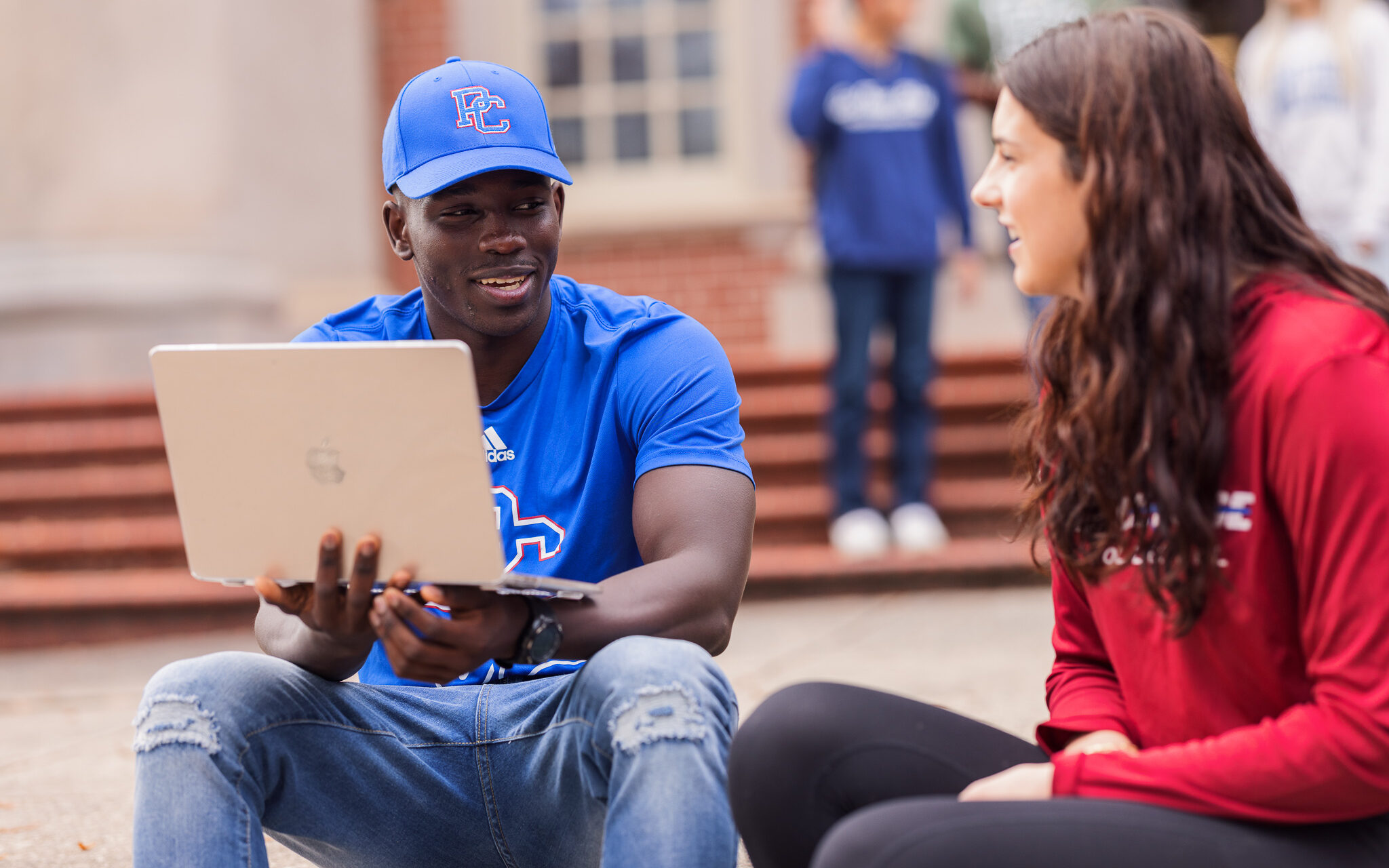 Two Presbyterian College students sitting in front of Thomason Library