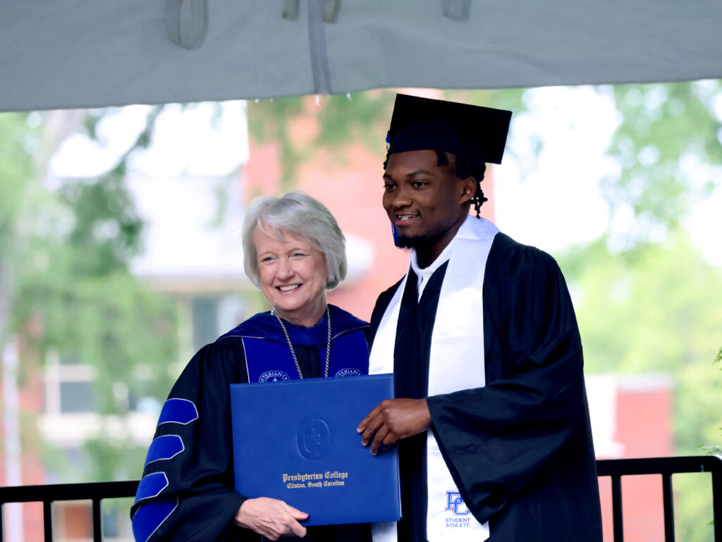 President Gustafson with student at graduation.