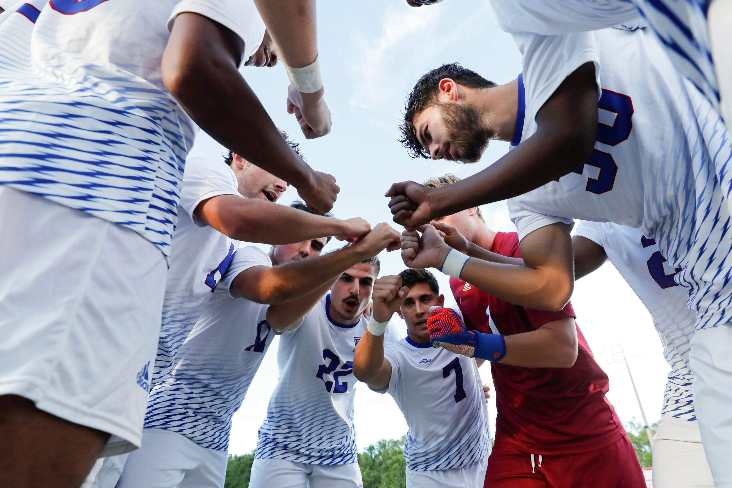 A photo of the Men's Soccer team breaking down a huddle.