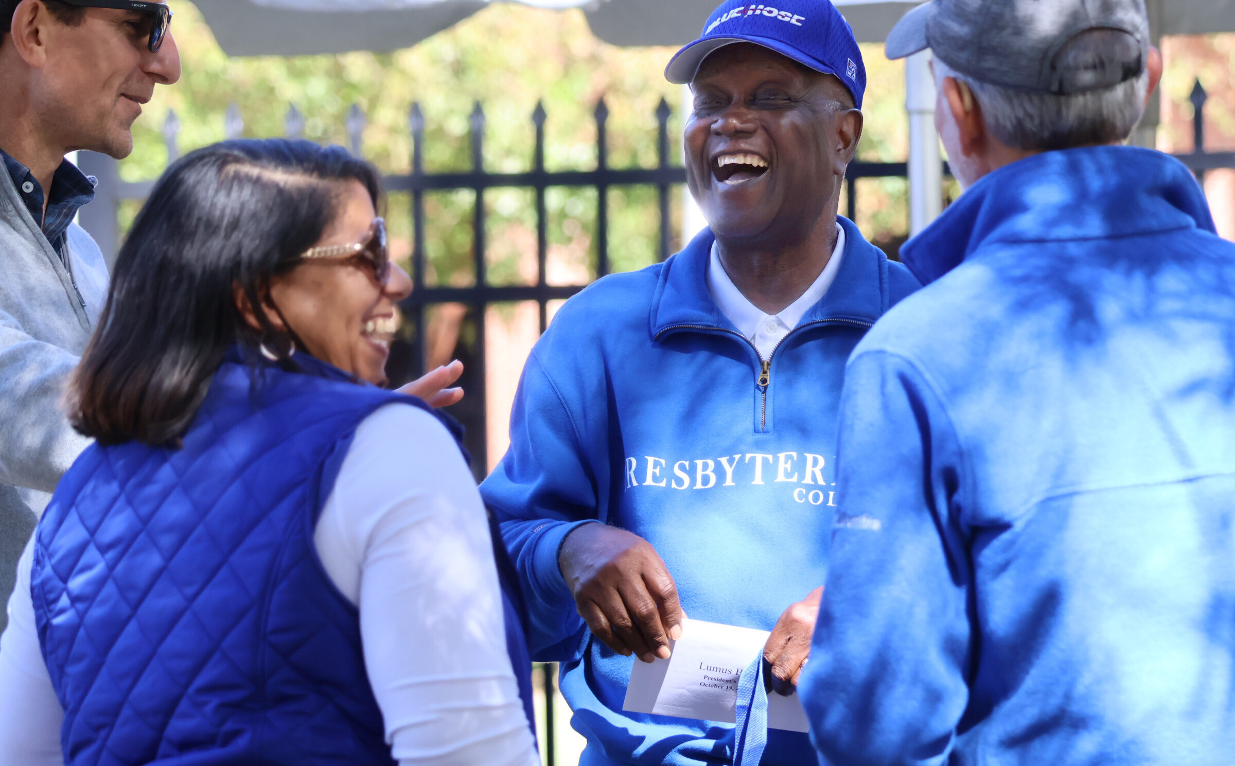 Alumni and friends laughing and talking at the annual True Blue Tailgate at Presbyterian College