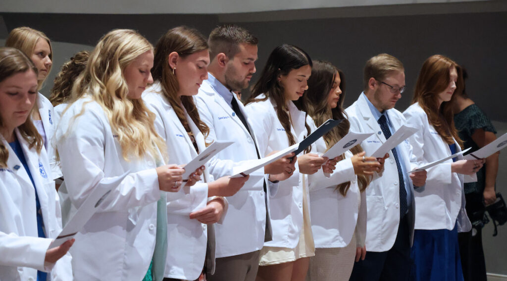 Members of the Presbyterian College Physician Assistant Program Class of '26 reciting a pledge during their White Coat Ceremony on Sept. 27, 2025.