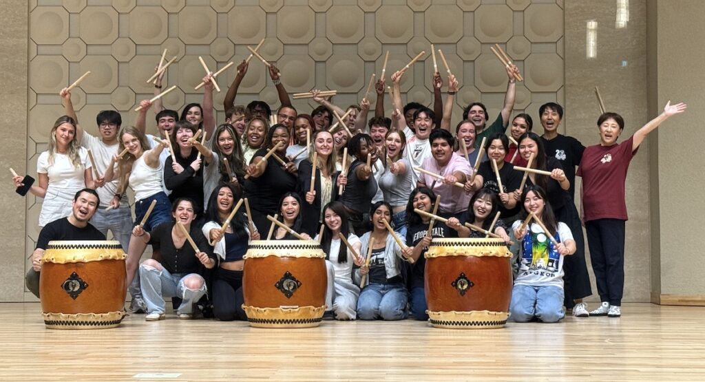 PC students enjoying a drum lesson during their Maymester trip to Japan.
