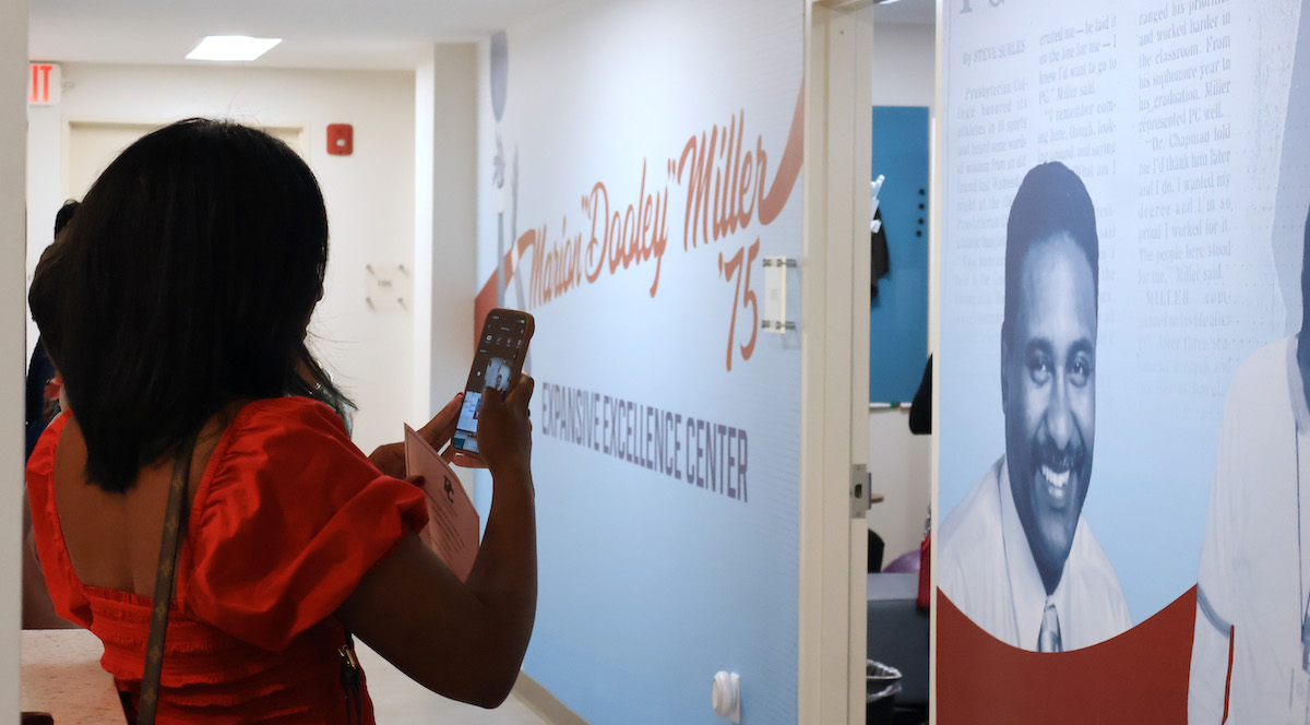 A family member captures a photo at the dedication of the Marion 