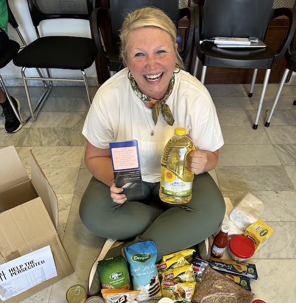 PC graduate Jessica Jetton '99 gathering food for Help the Persecuted, a ministry devoted to helping Christian converts facing oppression and violence.