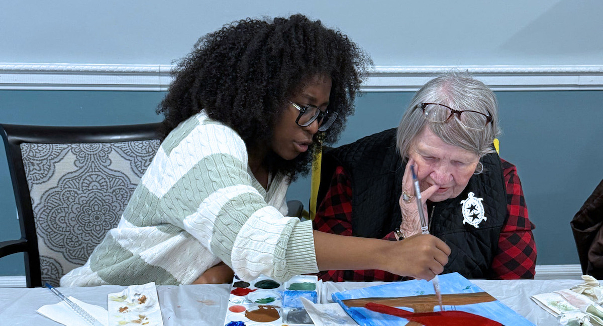 A Presbyterian College students volunteering for an art class with residents at Clinton Presbyterian Communities.