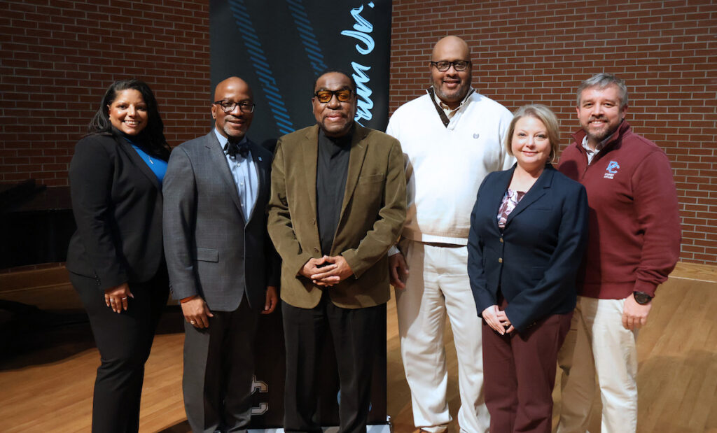 Darrin Goss Sr. with professor emeritus Dr. Booker T. Ingram Jr. and member of college leadership.