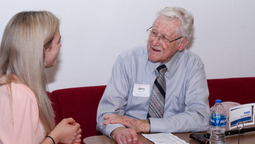 Jerry Smith '50 speaking to a student at PC's Mocktails and Mingling.