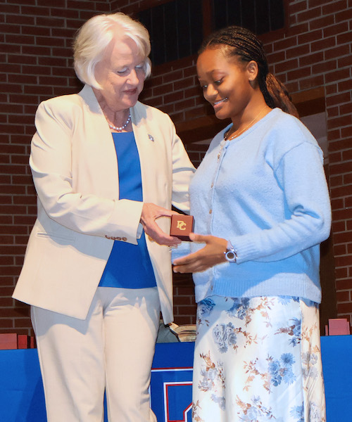 A Presbyterian College student receives her class ring from PC president Dr. Anita Gustafson.
