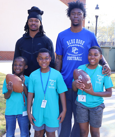 Two members of the Blue Hose football team play catch with special Olympians at the 2026 Area 6 Special Olympics hosted by Presbyterian College.