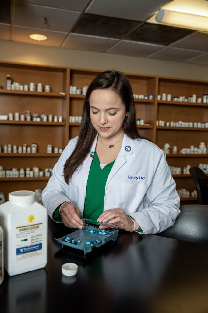 Pharmacy student working with medications.