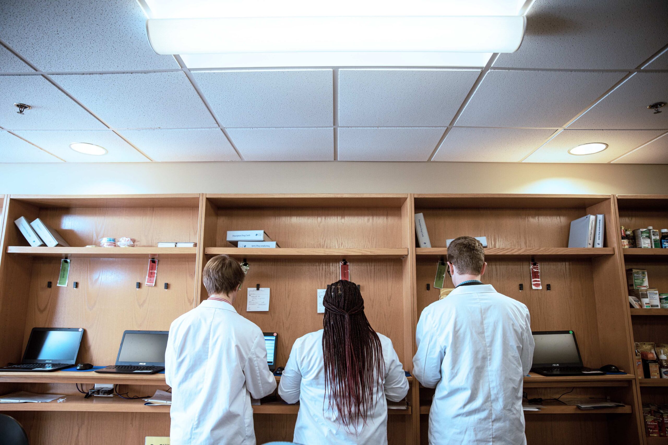 Pharmacy students doing work in a classroom.