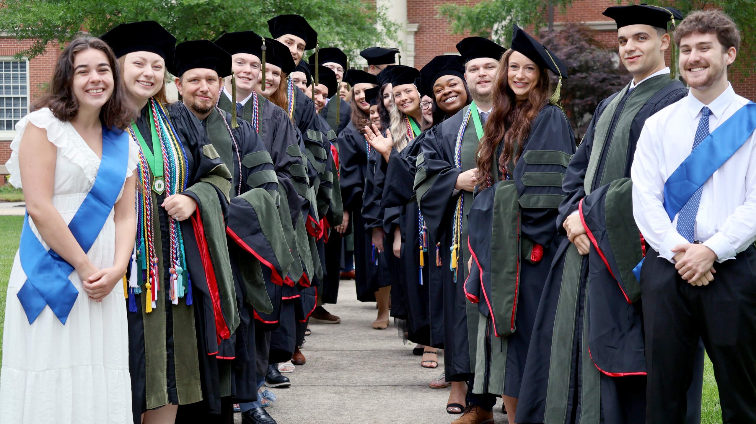 Pharmacy graduates pose for a group photo before they proceed into commencement.