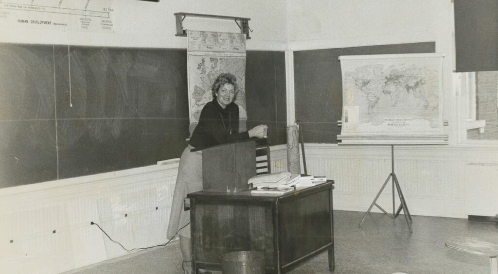 Bland and white photo of professor emerita of psychology Dr. Ann Stidham in a classroom.