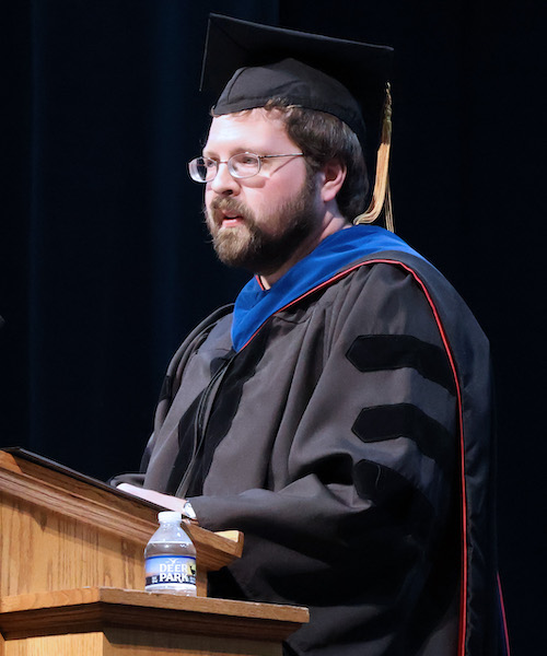 Dr. Eli Owens, associate professor of physics, delivering the keynote address at the 2026 Honors Day convocation at Presbyterian College.