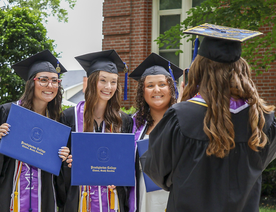 Sorority sisters from Sigma Sigma Sigma take pictures together after graduating on May 9 from Presbyterian College, a prominent liberal arts college.