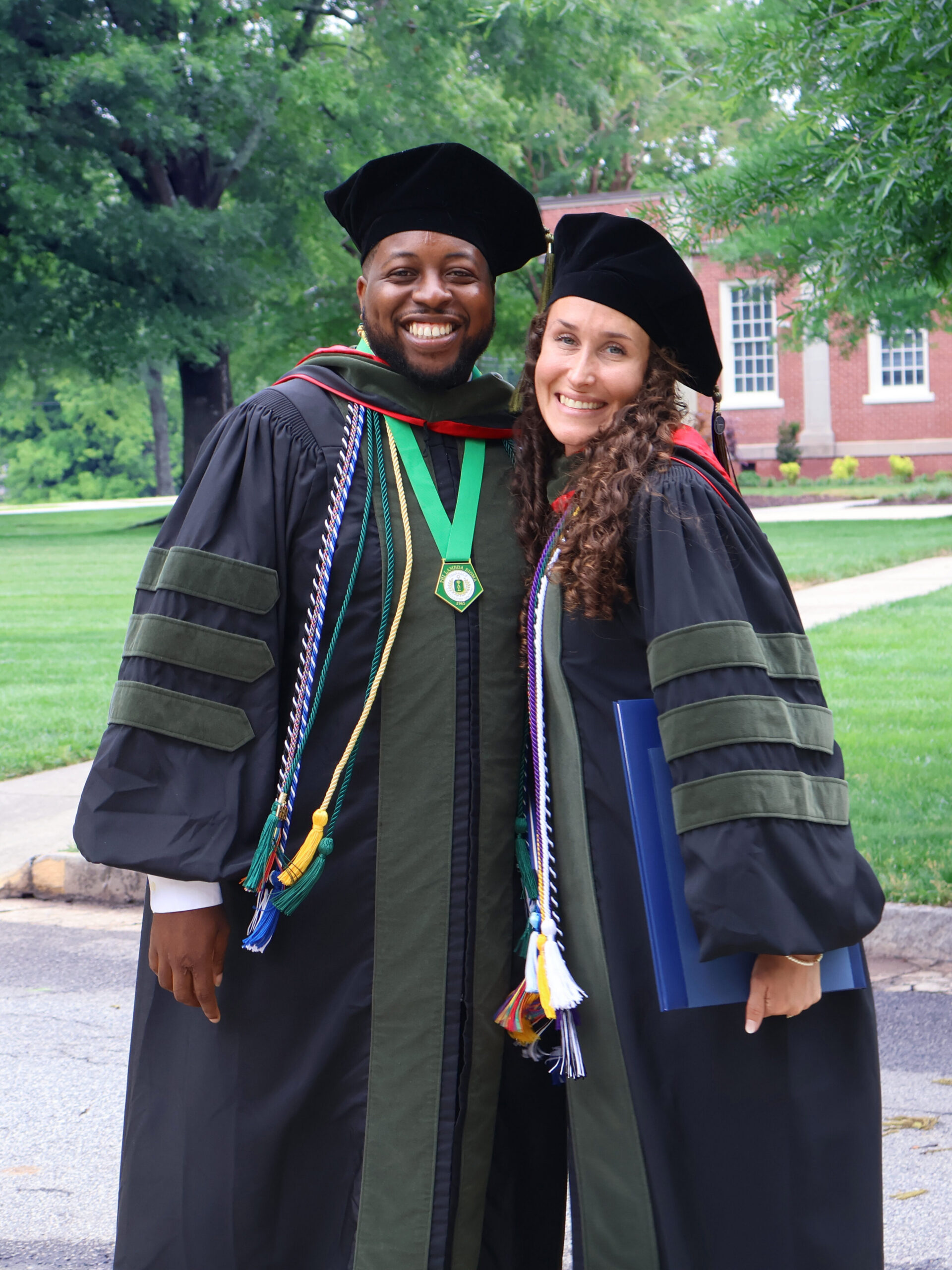 Two Pharmacy graduates posing for a photo