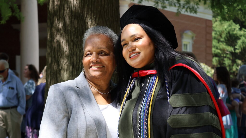 A new doctor of pharmacy is congratulated by family following her hooding ceremony at Presbyterian College.