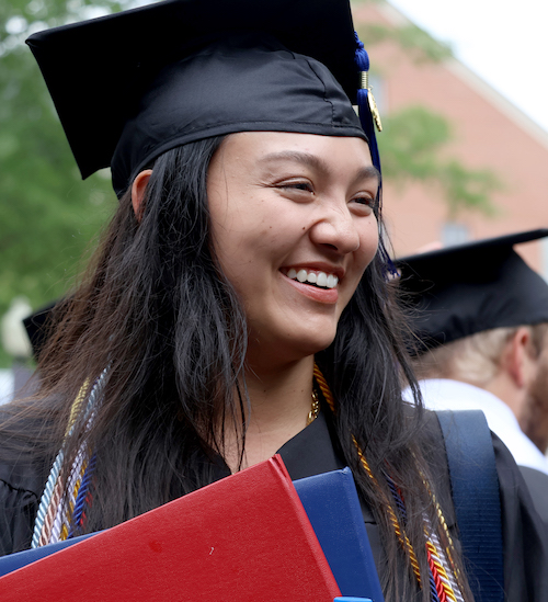 Vanessa Palisin, one of five co-valedictorians at PC, celebrates after graduating summa cum laude with honors in business administration.