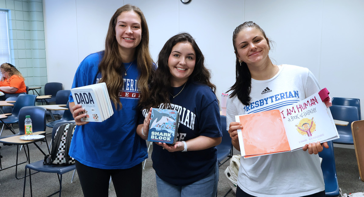 PC special education students work on a project together to help students with special needs read books.