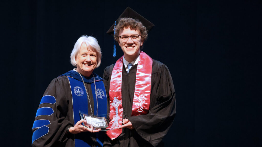 Presbyterian College graduate Lyle Jones '26 receiving an award from PC president Dr. Anita Gustafson at the Honors Day Convocation in April.