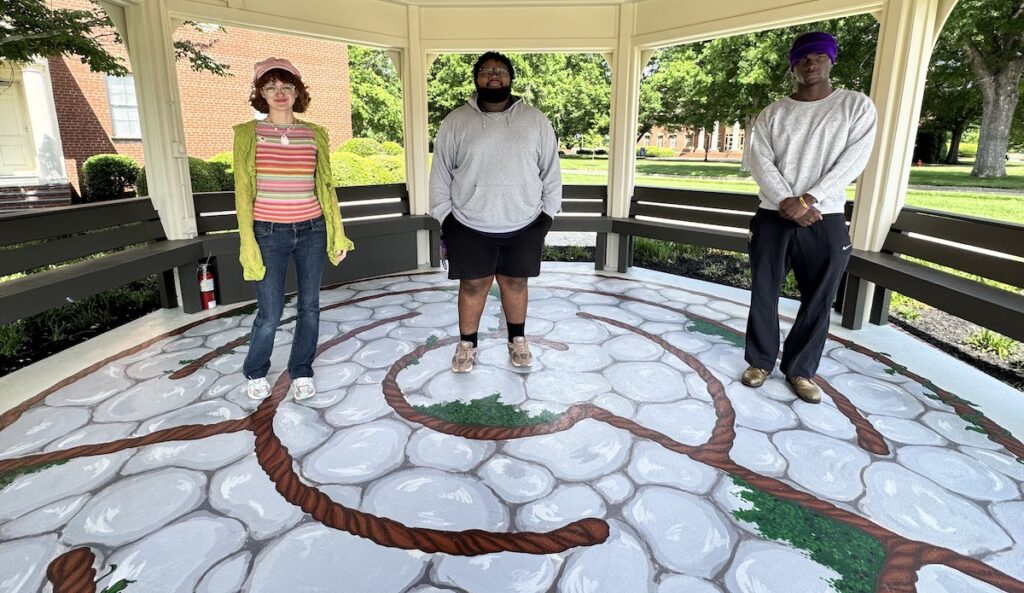 PC students Lauren Smoak, Peyton Phillips, MaLek Horlback, and Peyton Phillips stand over their work on the labyrinth in PC's new Peace Pavilion.