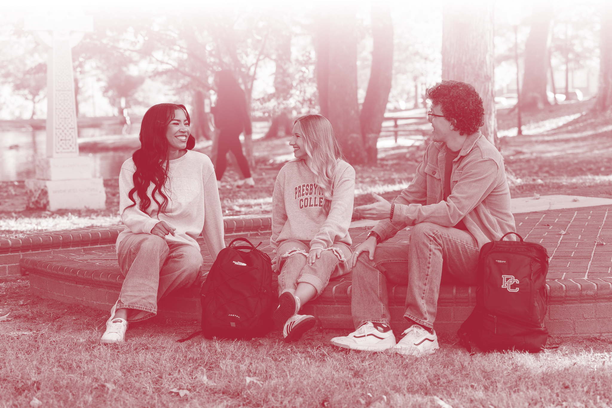 Three students sitting outside and talking at Presbyterian College