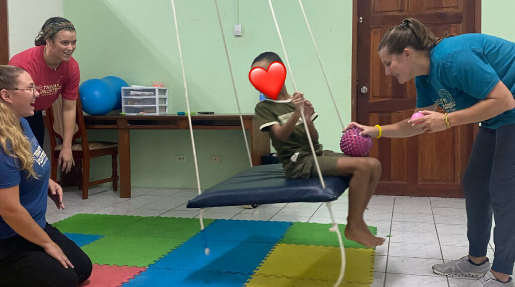 Presbyterian College Occupational Therapy Doctoral Program students working with a Belizean child during a trip to Belize last summer.