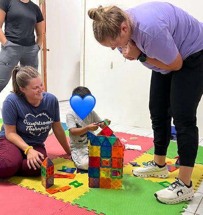Presbyterian College Occupational Therapy Doctoral Program students working with a Belizean child during a trip to Belize last summer.