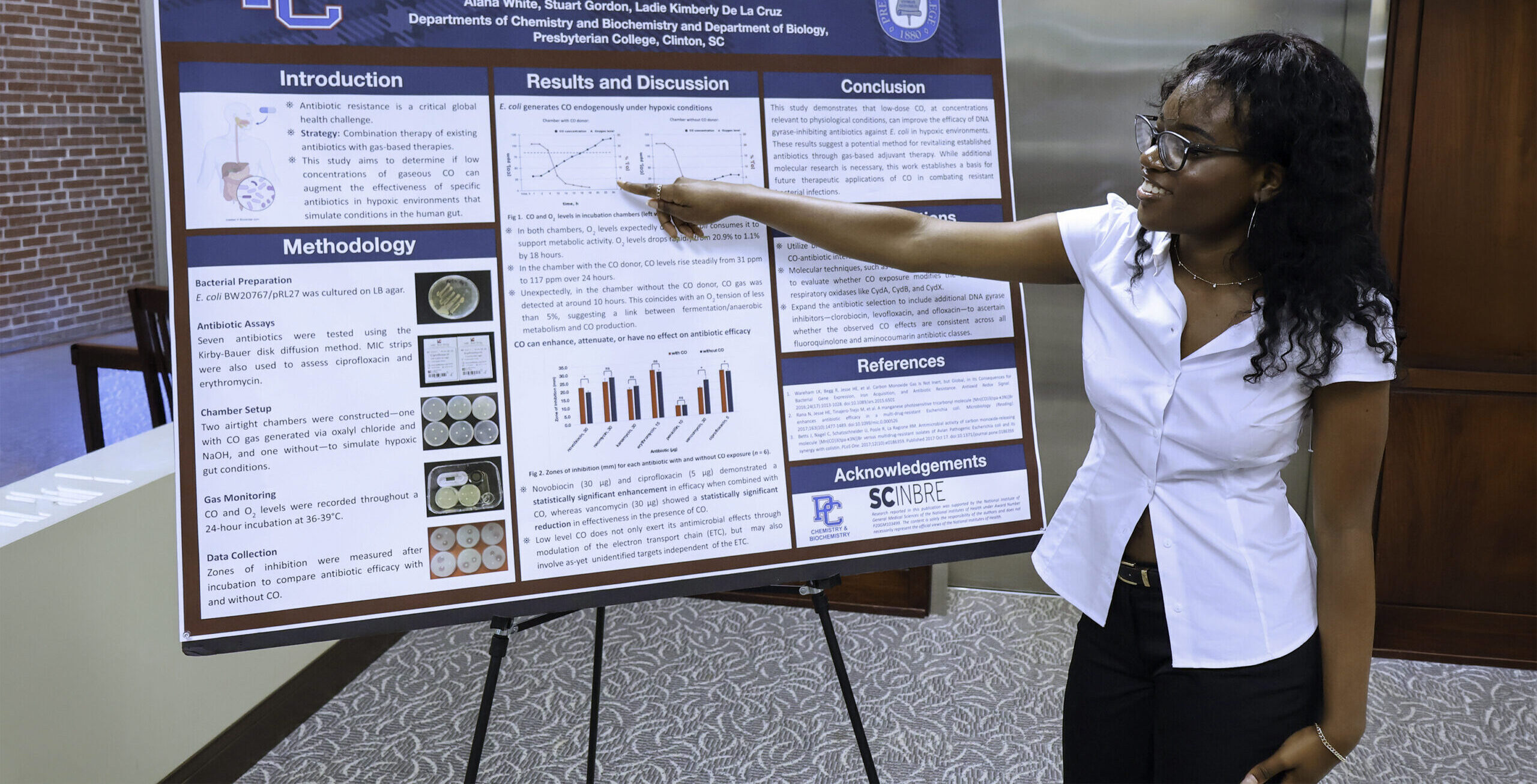 Student presenting a research poster at the 2026 Summer Symposium
